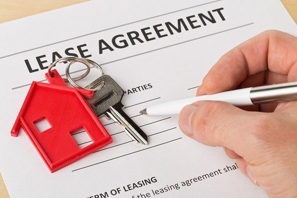 House Rental Agreement with key on the table